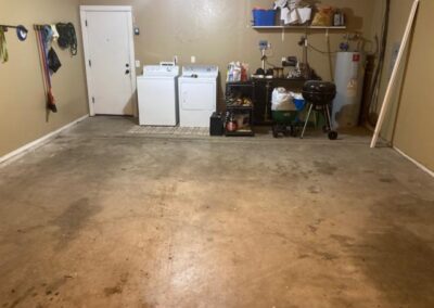 An empty garage with a washer and dryer.