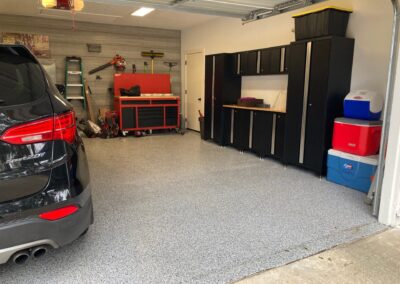 A black car is parked in a garage.