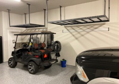 A golf cart is parked in a garage.