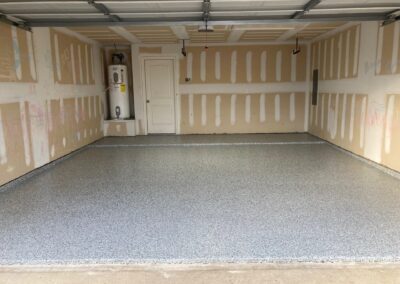 A garage with a floor that is being refinished.