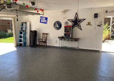 A garage with a white floor and a cowboys sign.